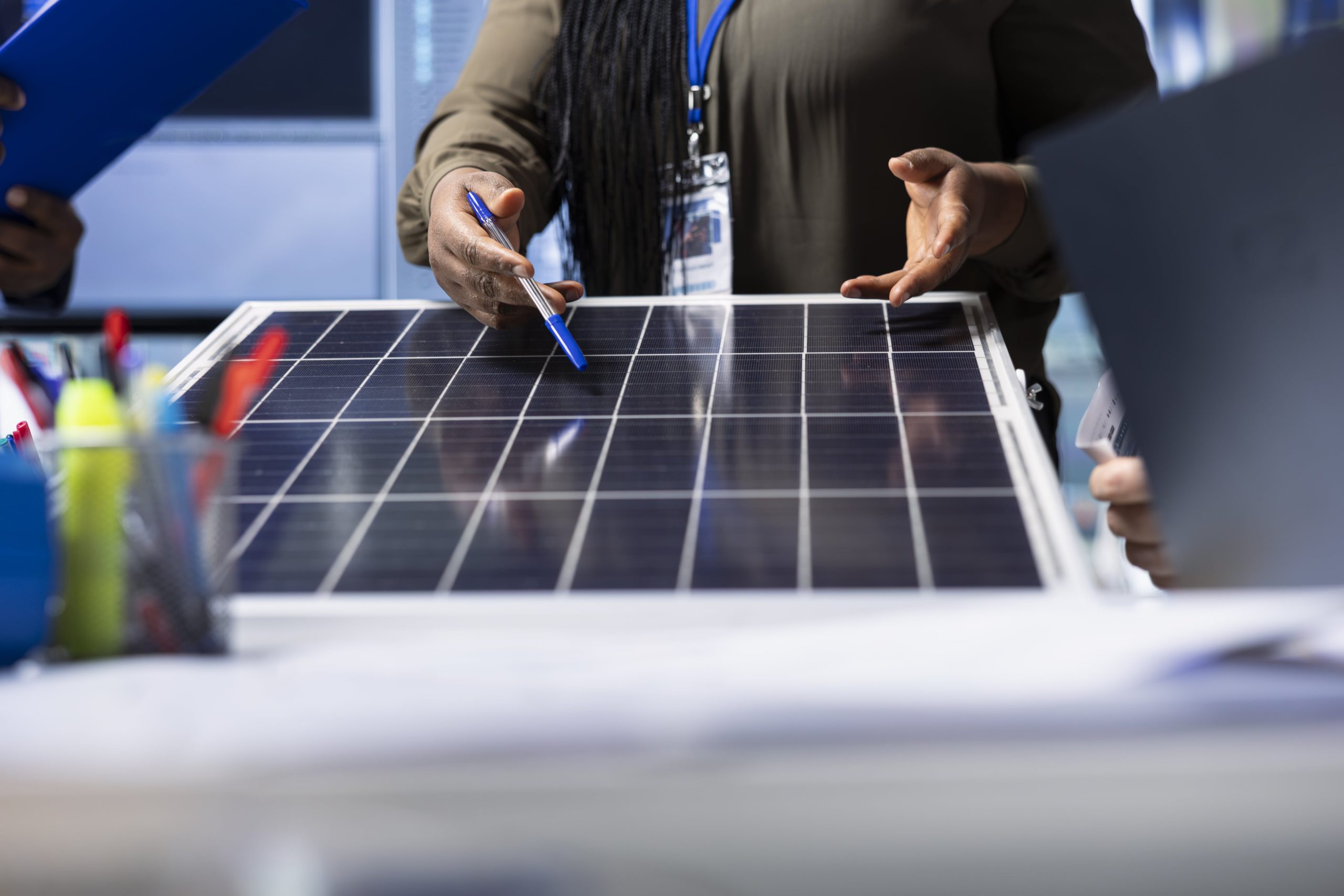 photovoltaics-factory-expert-reviewing-solar-panel-design-close-up-min
